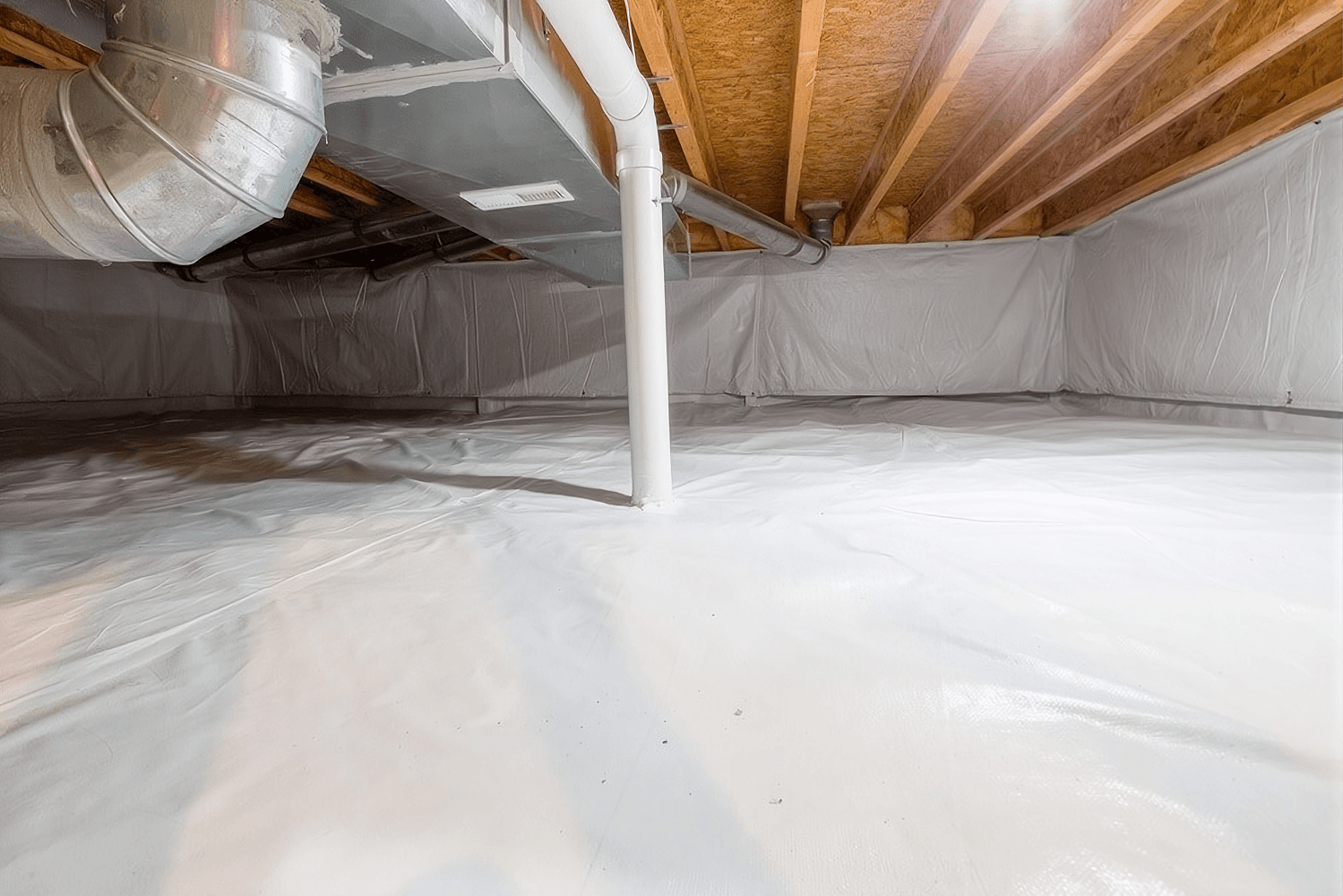 Crawlspace interior with white vapor barrier covering floor and walls, exposed wooden floor joists and support beam, white PVC pipe, and metal ductwork visible overhead.